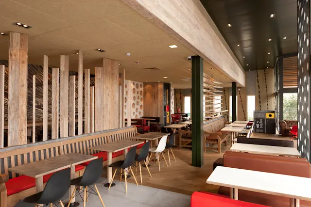 Interior view of dining area in McDonald’s Antas restaurant in Porto, Portugal — designed by architect Ilaria Gatto, featuring contemporary interior design elements.
